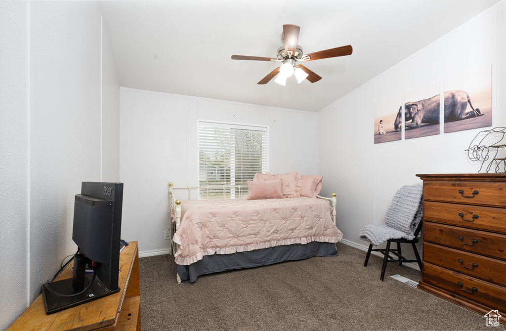Bedroom featuring baseboards, carpet, and ceiling fan