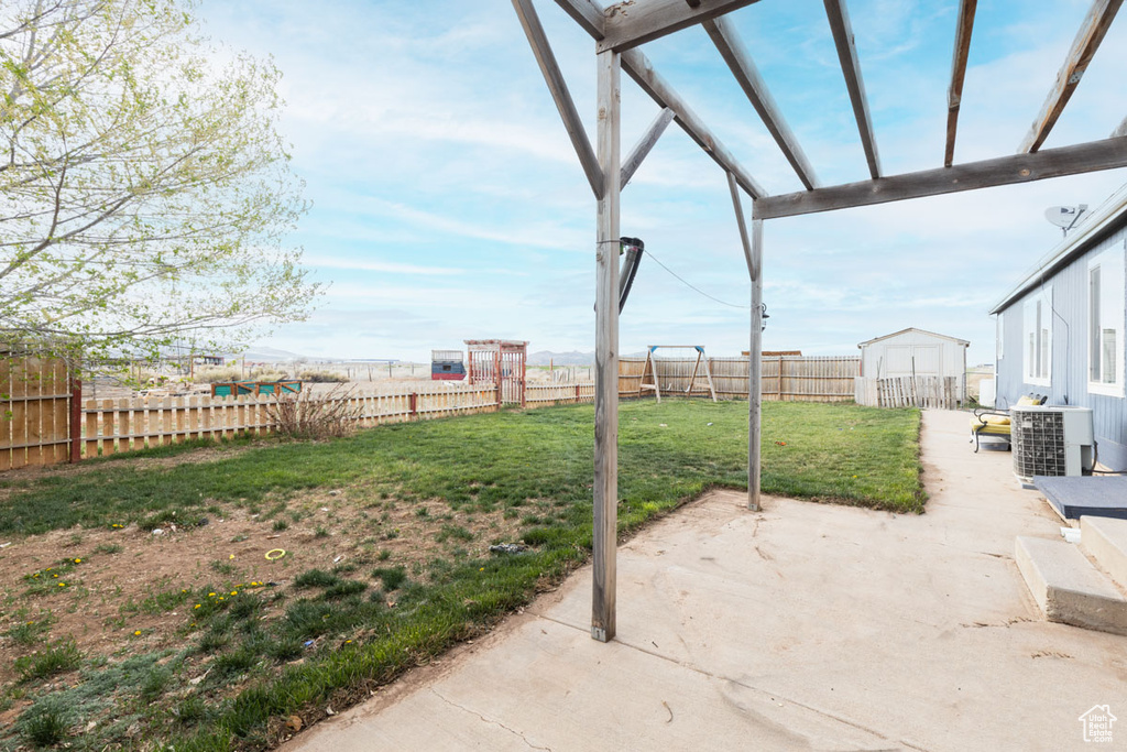 View of patio featuring a fenced backyard and cooling unit