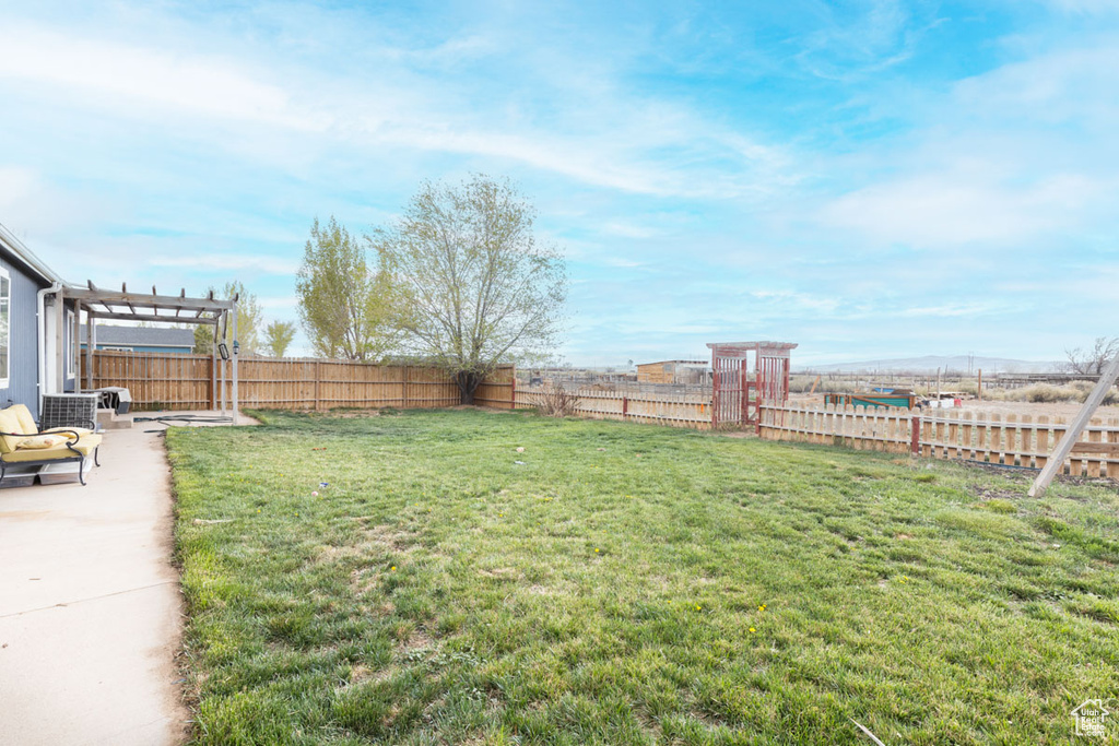 View of yard with a fenced backyard, a patio area, and a pergola