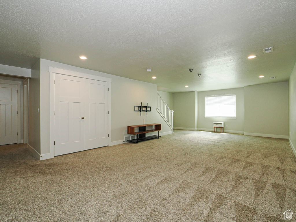 Below grade area with stairway, carpet, recessed lighting, and visible vents