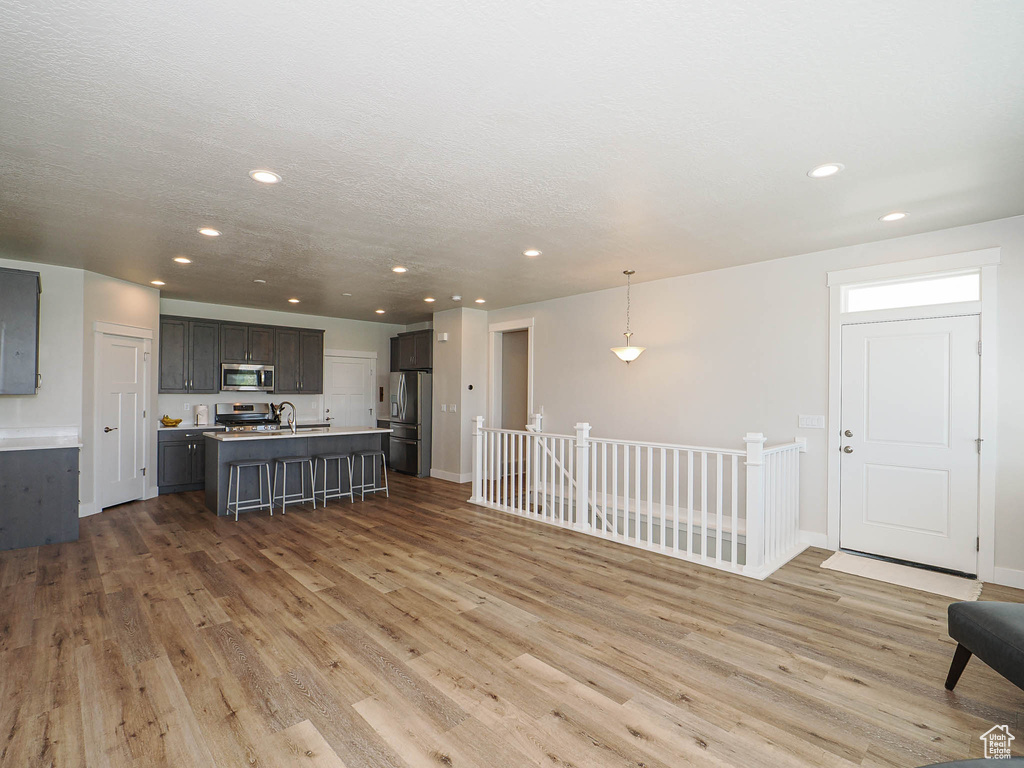 Living room featuring recessed lighting, baseboards, and light wood-type flooring