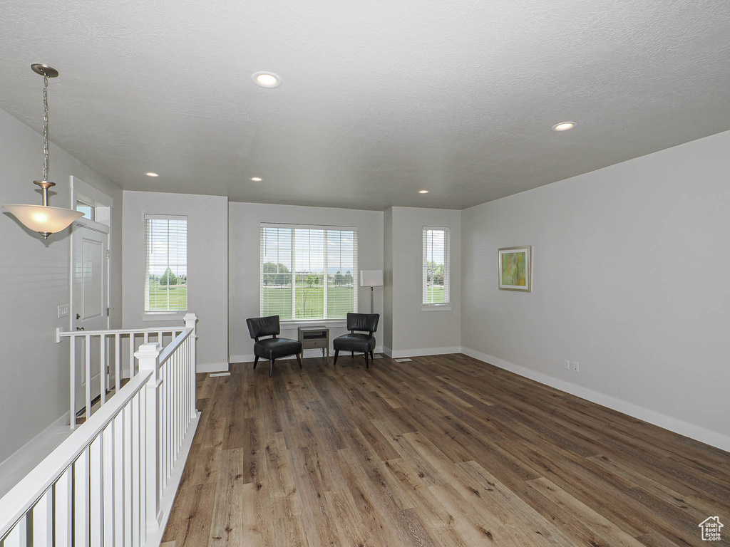 Sitting room featuring baseboards, recessed lighting, wood finished floors, and an upstairs landing