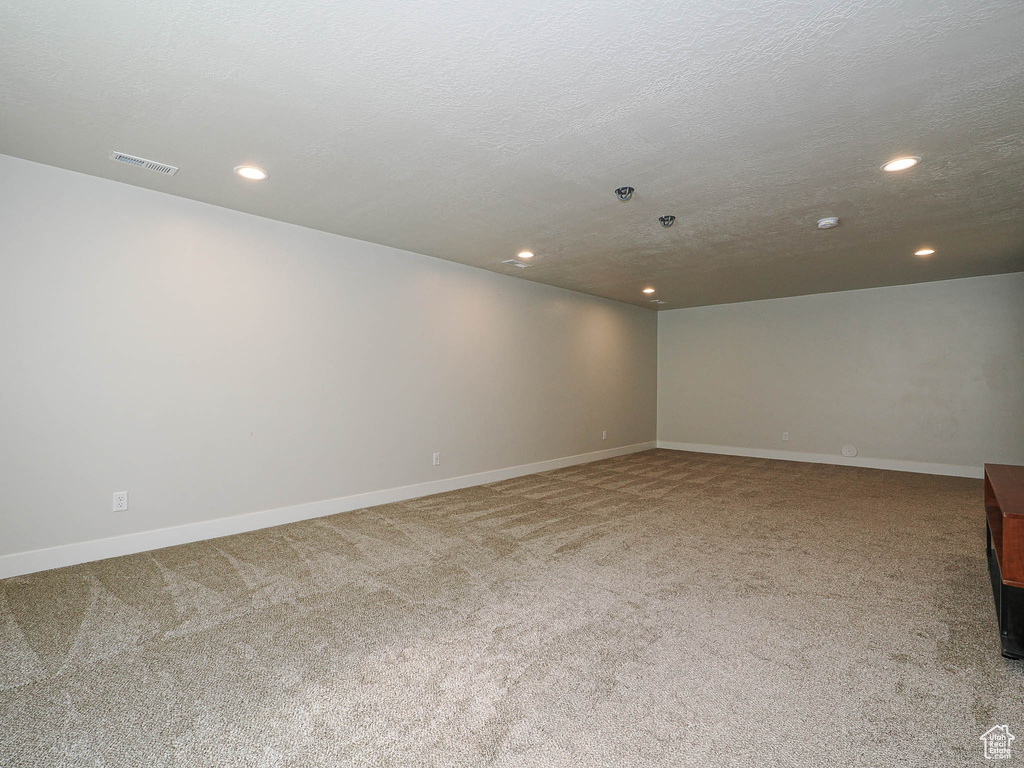 Spare room featuring recessed lighting, baseboards, visible vents, and carpet