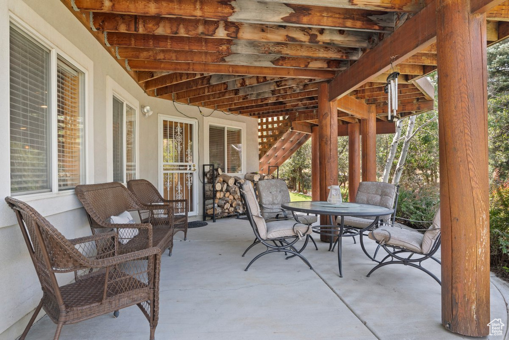 View of patio featuring outdoor dining space and stairs