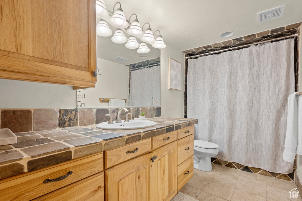 Bathroom featuring visible vents, tile patterned flooring, vanity, toilet, and a shower with curtain