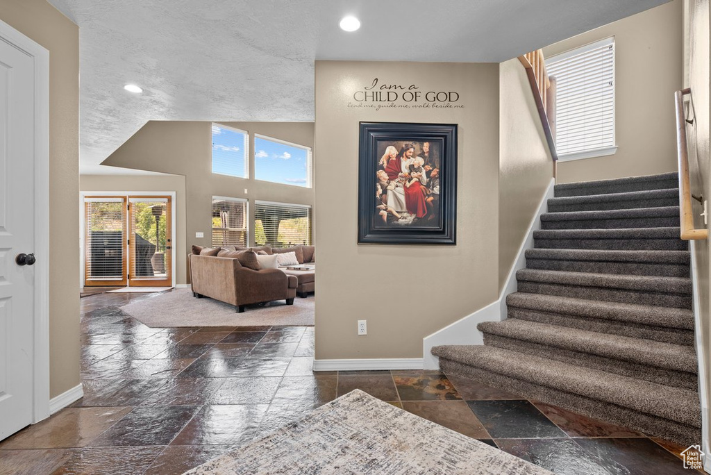 Staircase featuring stone tile flooring, recessed lighting, and baseboards
