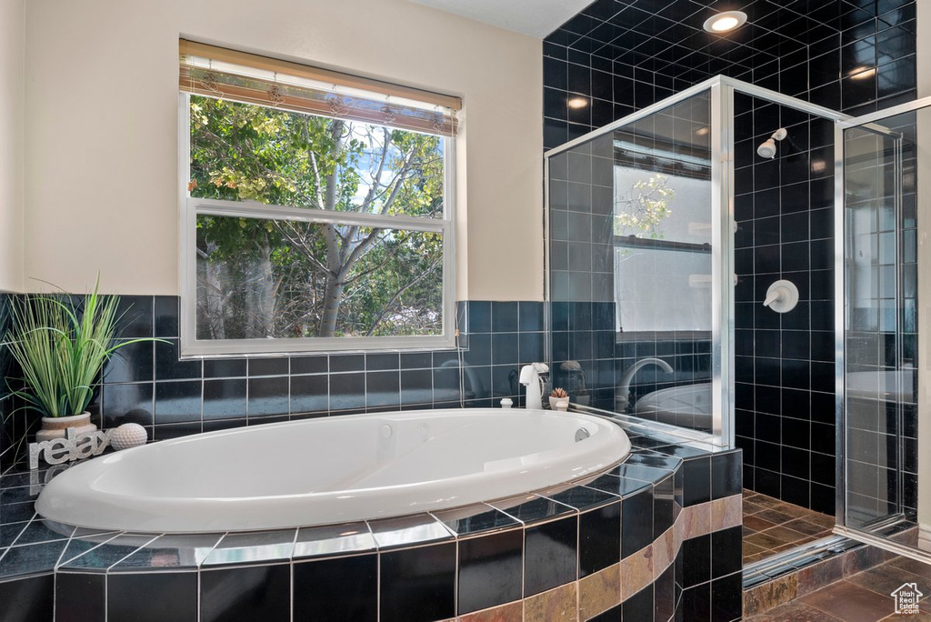 Full bathroom featuring a bath and a stall shower