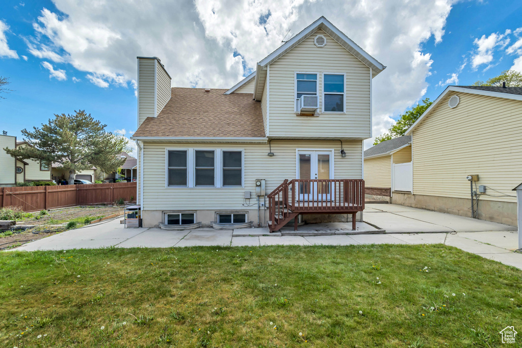 Rear view of house with fence, a patio, a chimney, and a yard