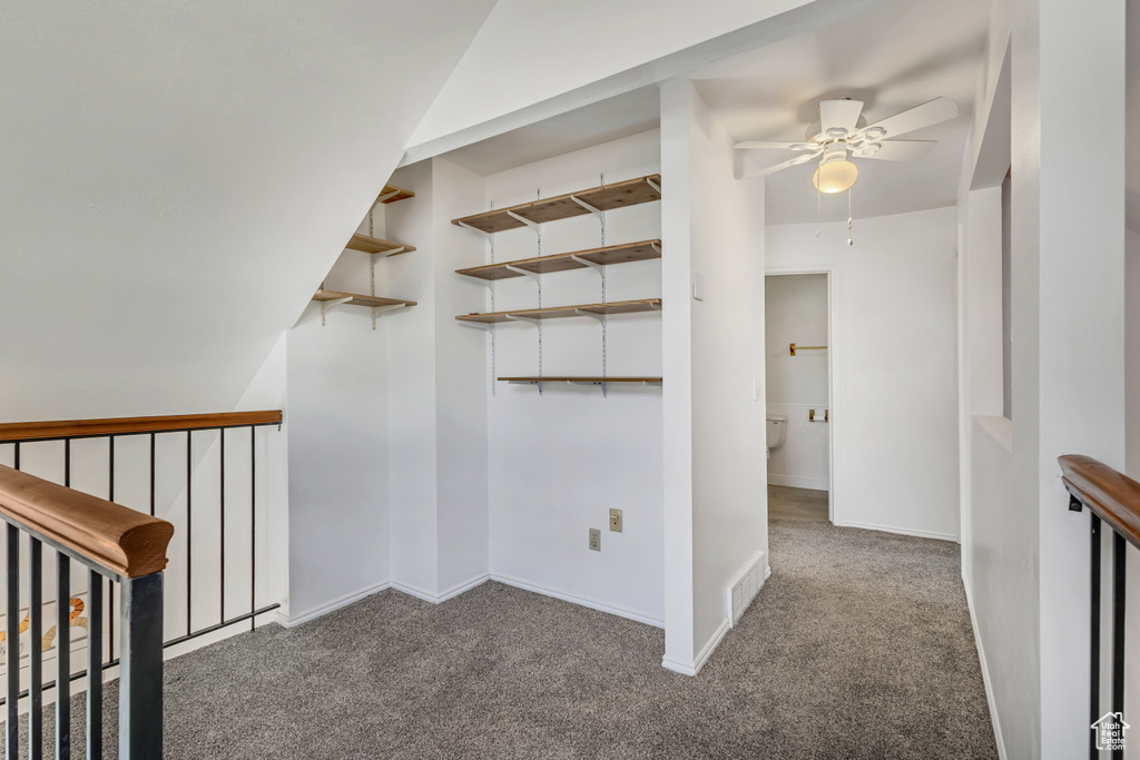 Hallway featuring baseboards, carpet flooring, and visible vents