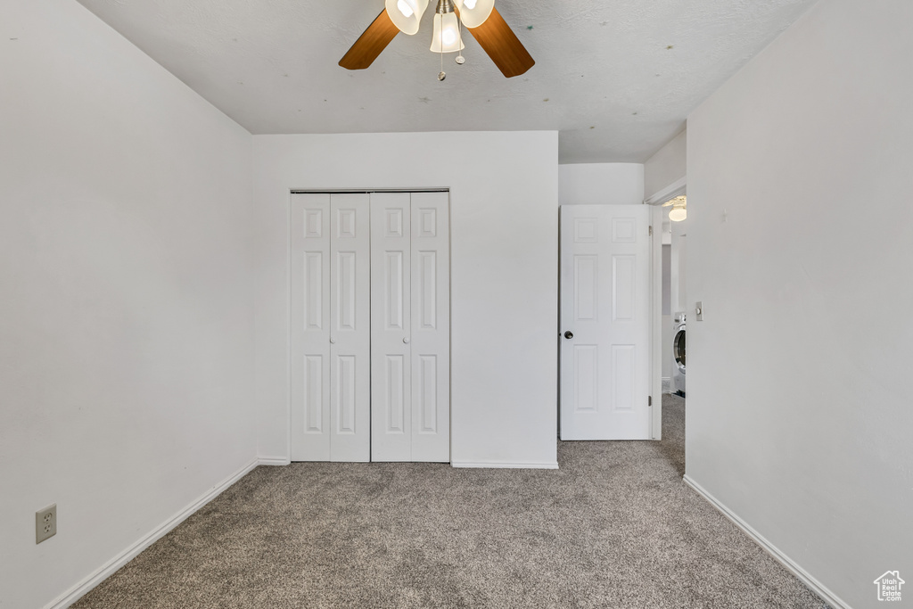 Unfurnished bedroom with carpet floors, baseboards, ceiling fan, and a closet