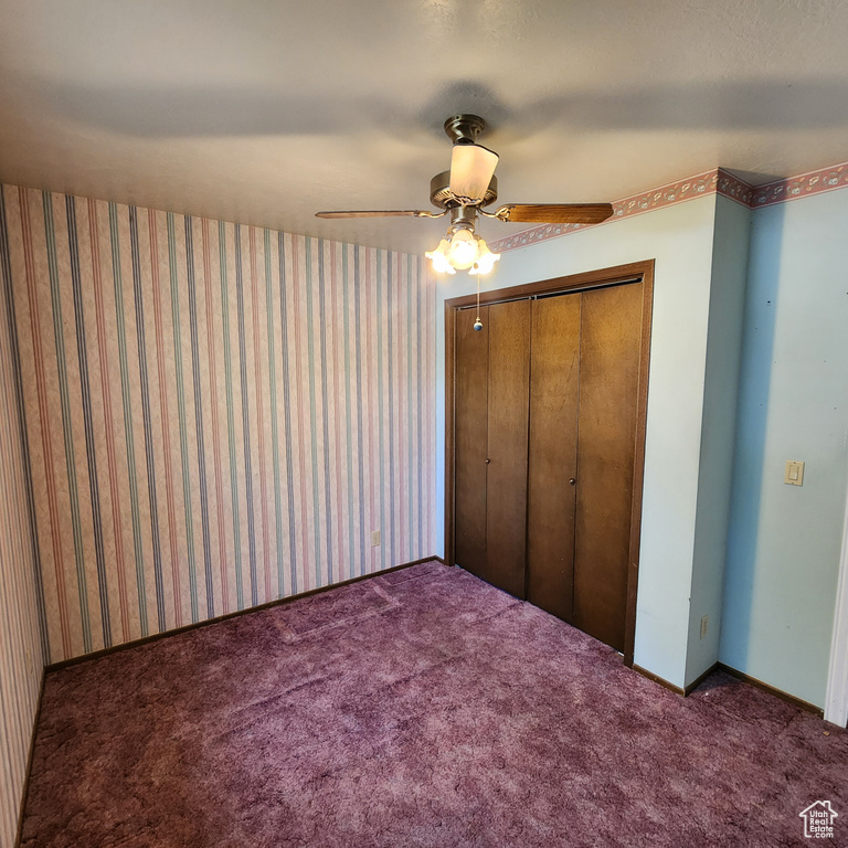 Unfurnished bedroom featuring a closet, a ceiling fan, and carpet