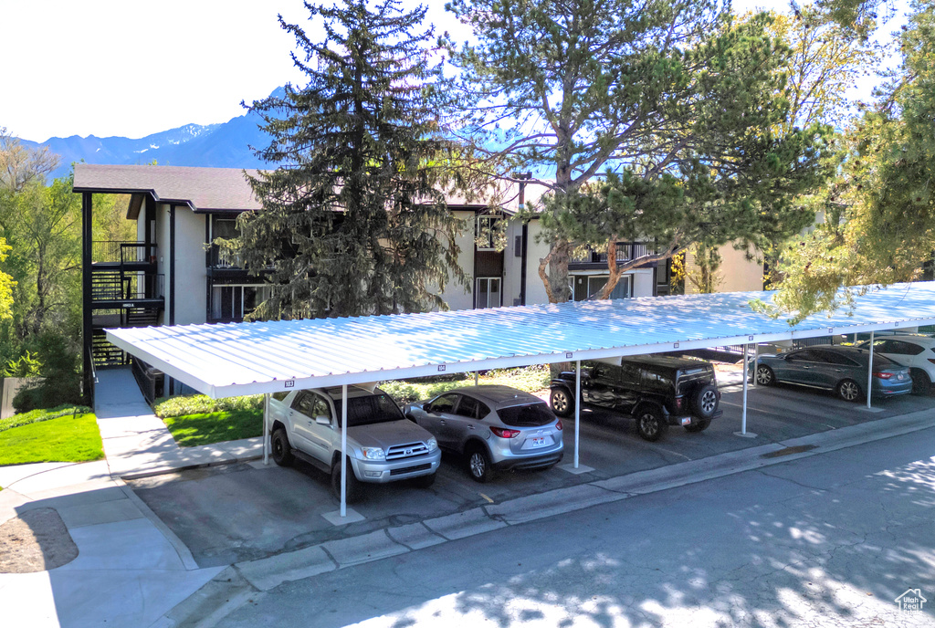 Covered parking lot featuring a mountain view