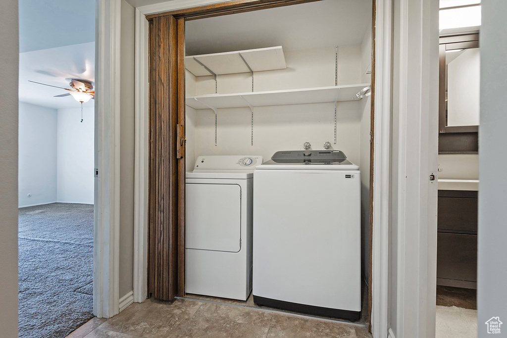 Laundry area with a ceiling fan, laundry area, washing machine and dryer, and light carpet
