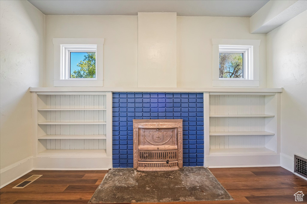 Interior details featuring baseboards, visible vents, and wood finished floors