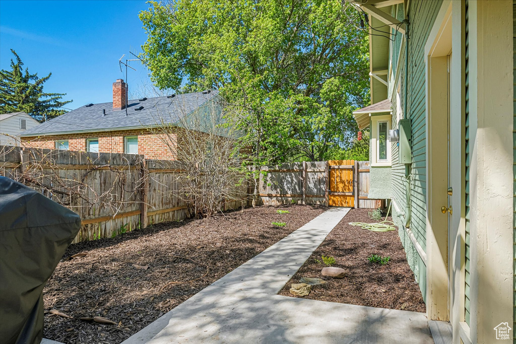 View of yard featuring a patio, a gate, and a fenced backyard
