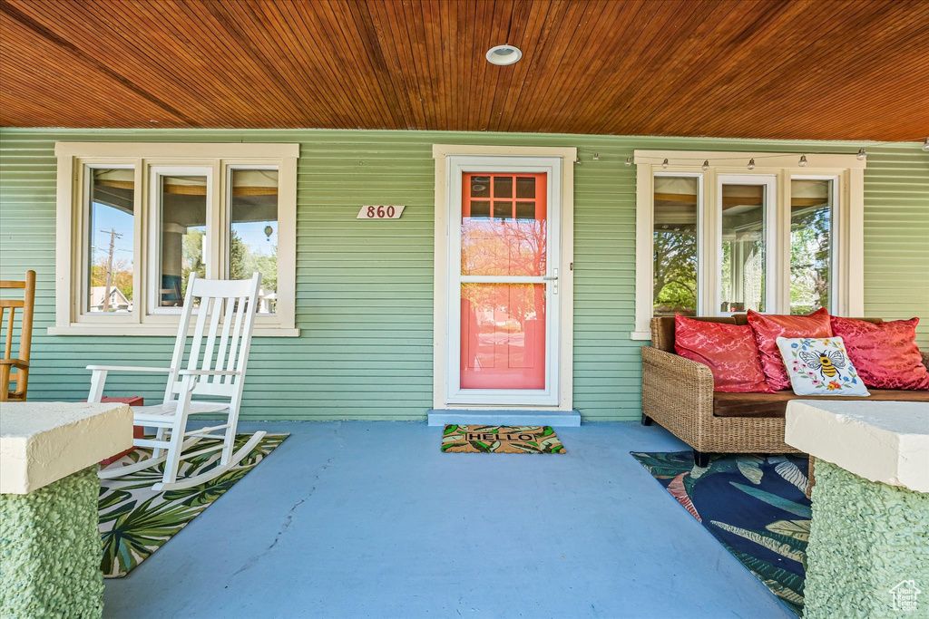 View of exterior entry with covered porch