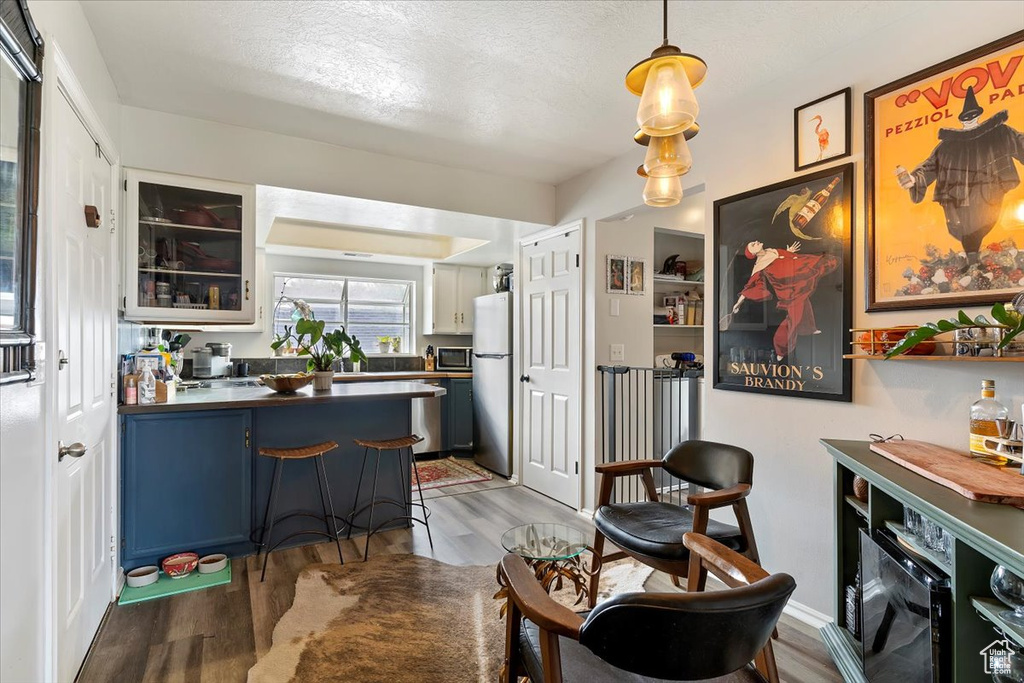 Interior space with a textured ceiling and wood finished floors