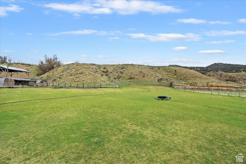 View of yard with fence and a mountain view
