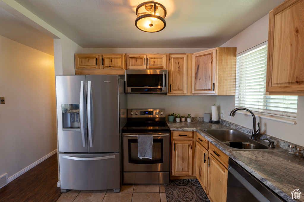 Kitchen with visible vents, a sink, appliances with stainless steel finishes, and light brown cabinets