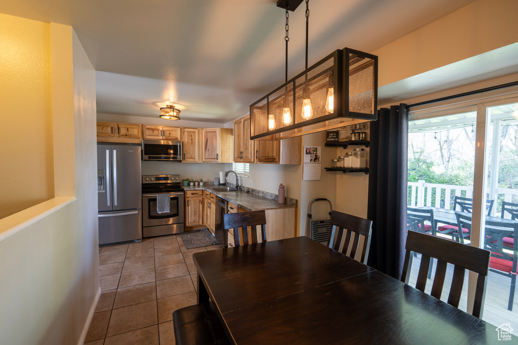 Dining space featuring dark tile patterned floors and baseboards