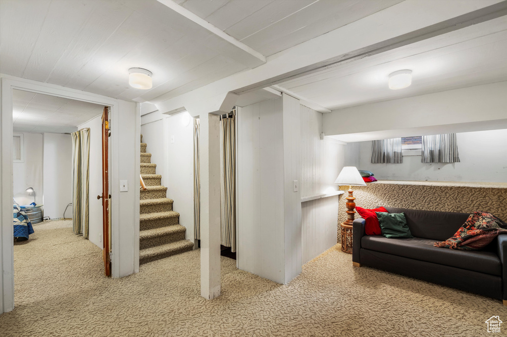 Finished basement with carpet flooring and stairs