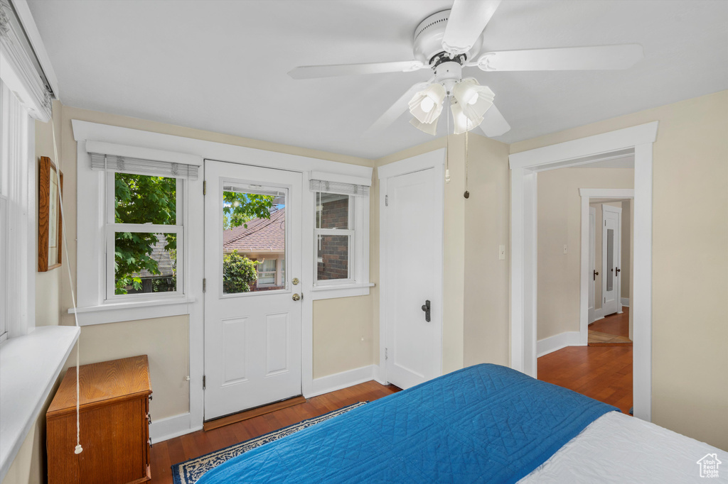 Bedroom featuring baseboards, ceiling fan, and wood finished floors