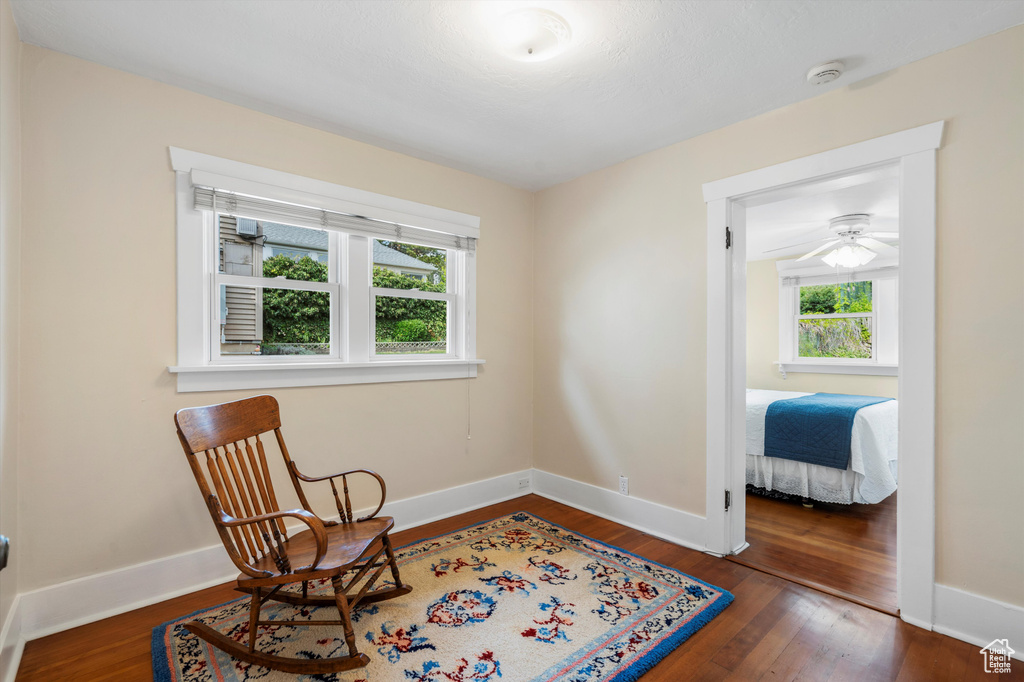 Sitting room with baseboards and wood finished floors
