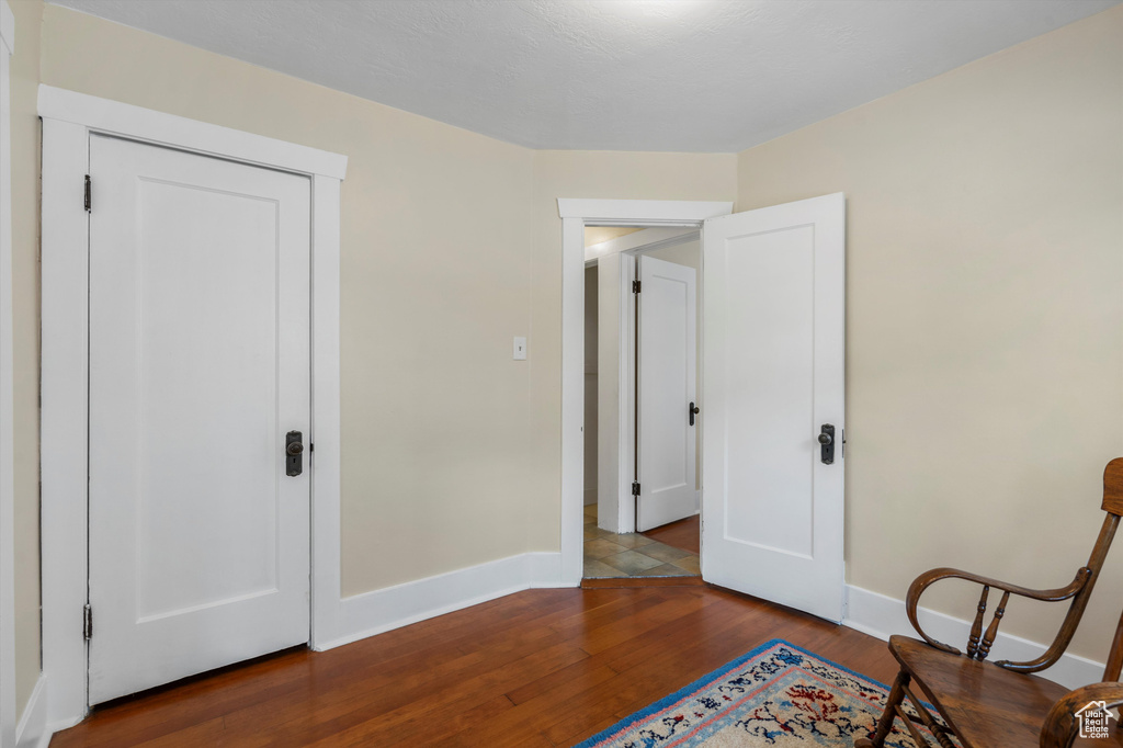 Sitting room with baseboards and wood finished floors