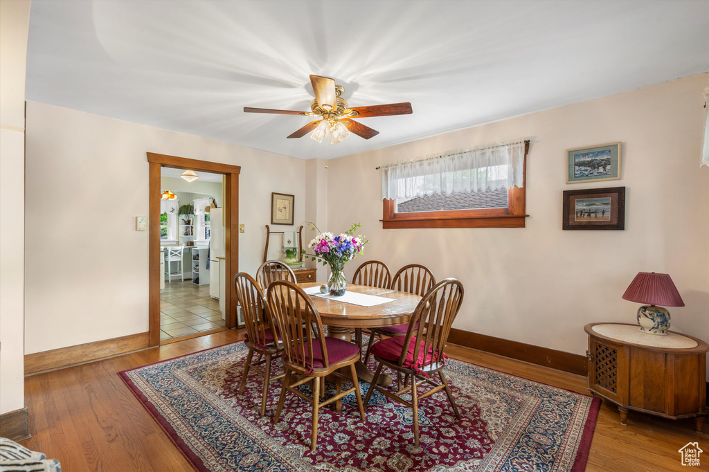 Dining space featuring baseboards, ceiling fan, and wood finished floors