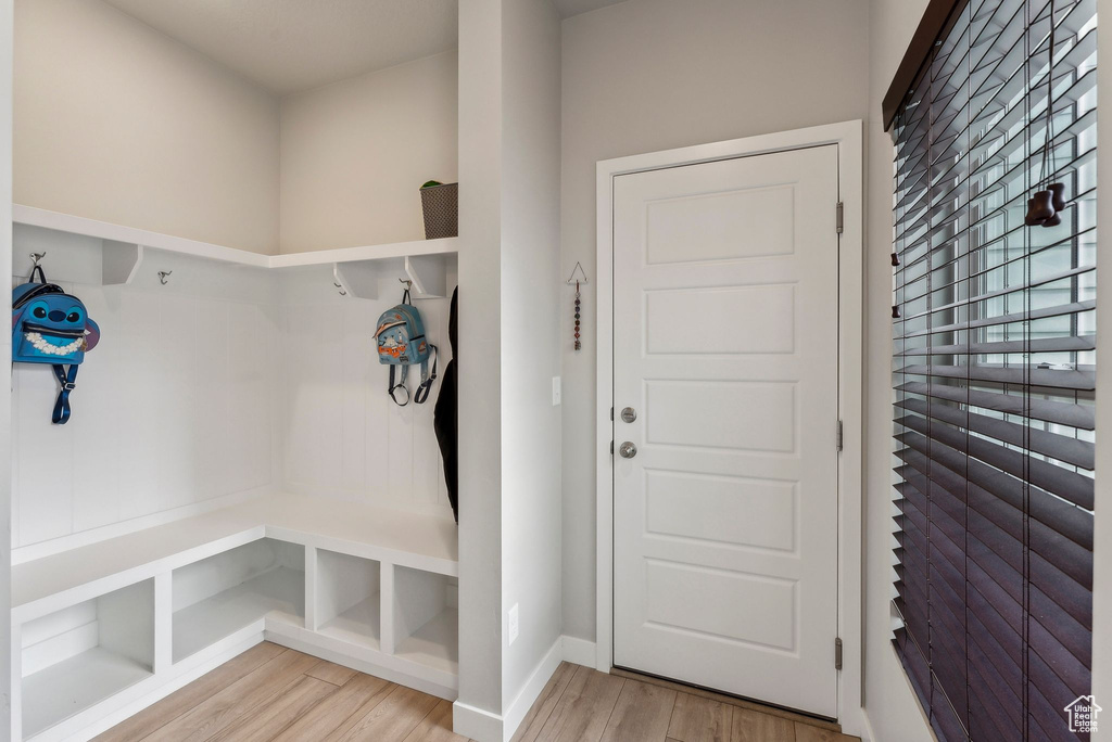 Mudroom with light wood-type flooring and baseboards
