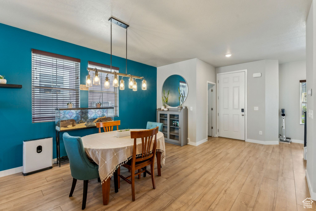 Dining room featuring recessed lighting, baseboards, and light wood finished floors