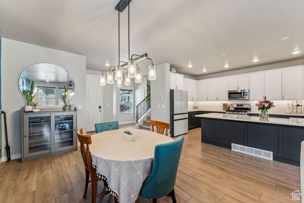 Dining space with stairway, recessed lighting, light wood-type flooring, and visible vents