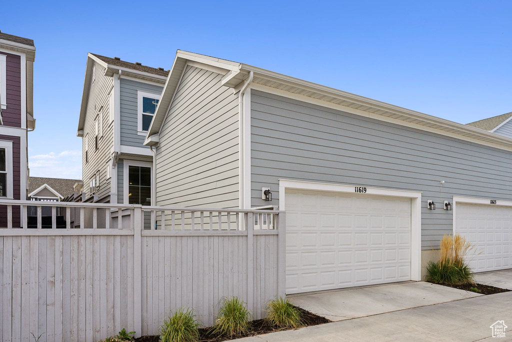 View of property exterior featuring fence