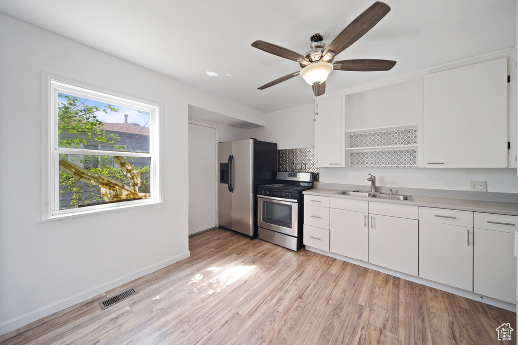 Kitchen with a ceiling fan, visible vents, appliances with stainless steel finishes, open shelves, and a sink