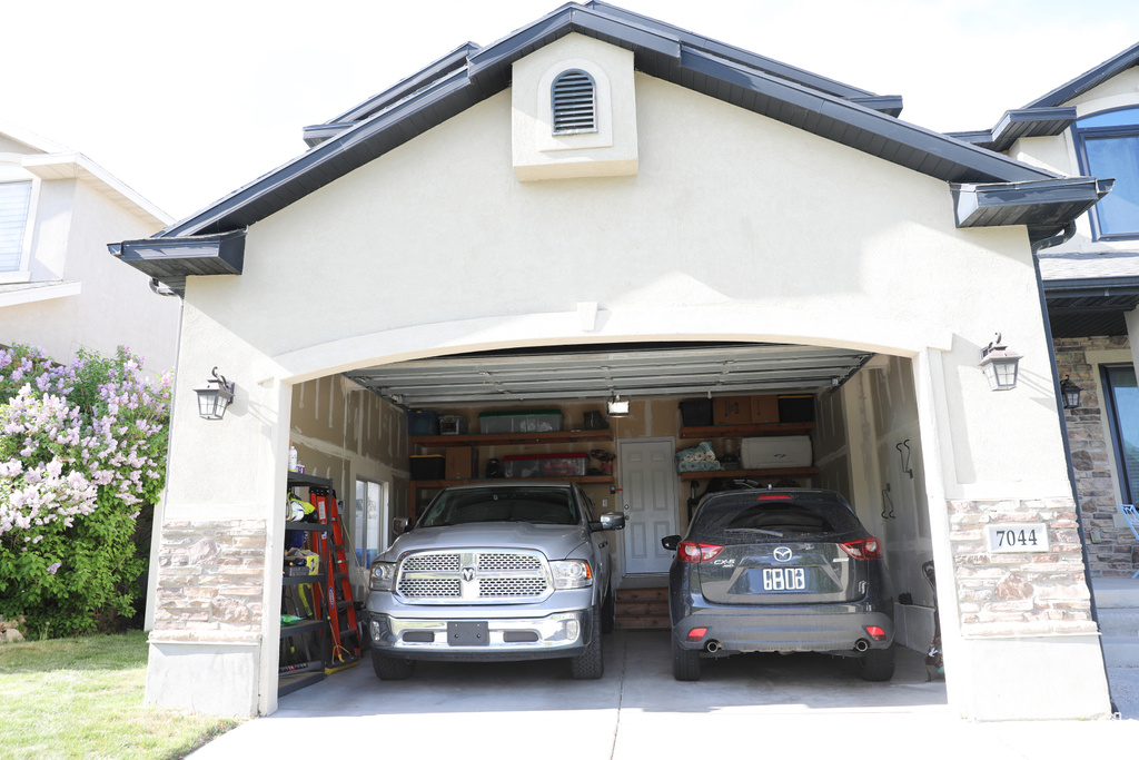 View of car parking featuring concrete driveway
