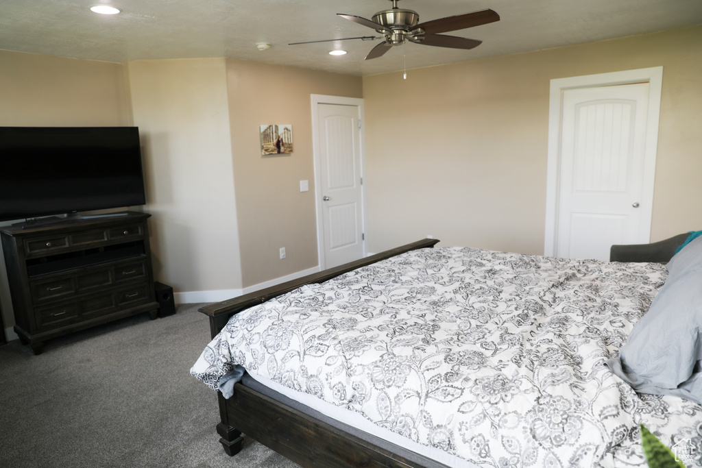 Carpeted bedroom with baseboards, ceiling fan, and recessed lighting