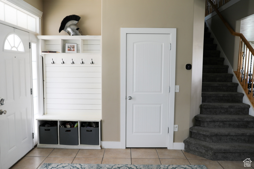 Mudroom featuring baseboards and light tile patterned floors