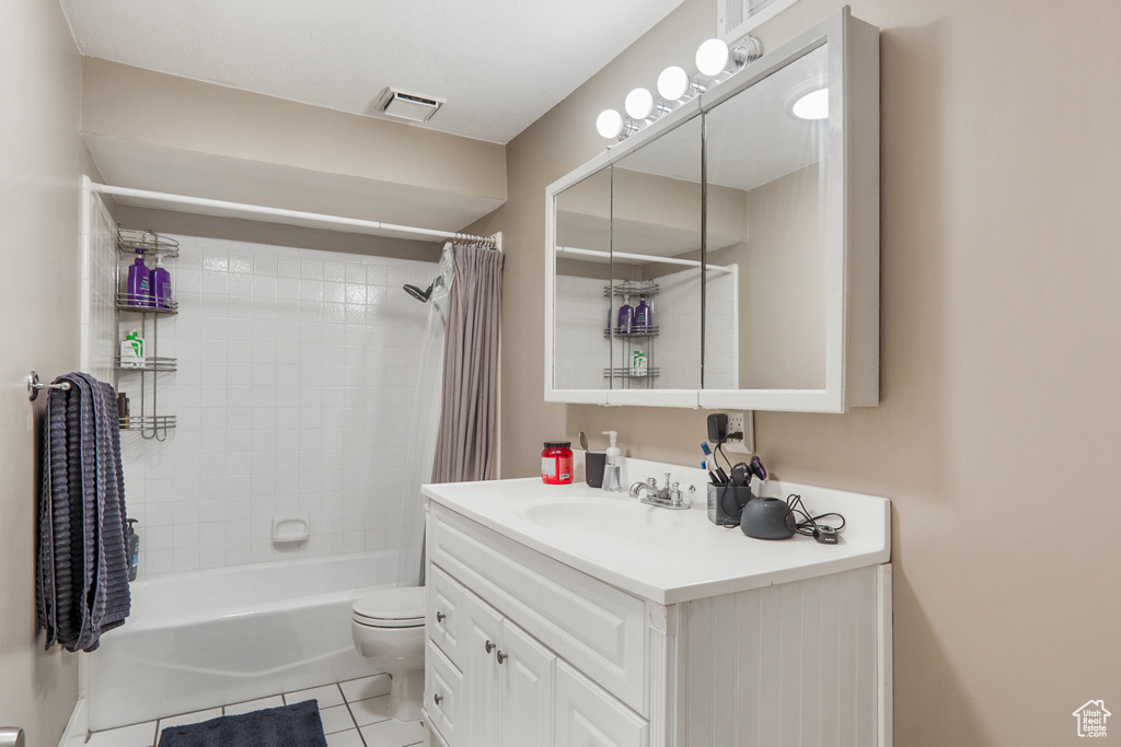 Bathroom with shower / bath combo, tile patterned flooring, vanity, toilet, and visible vents