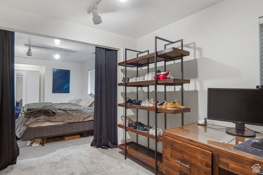 Bedroom featuring track lighting and carpet floors