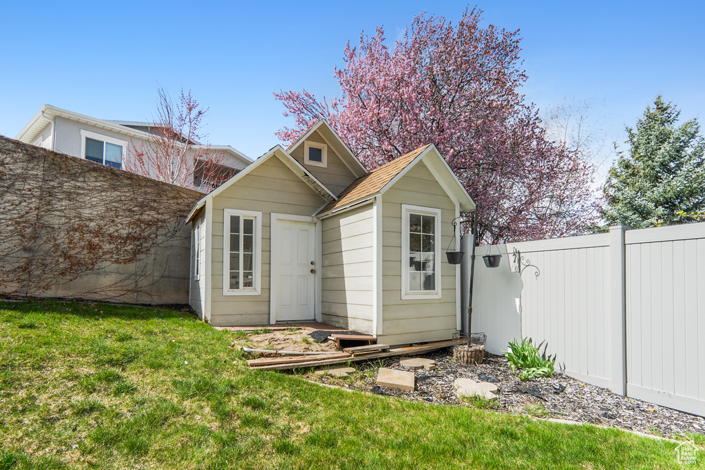 View of outbuilding with fence