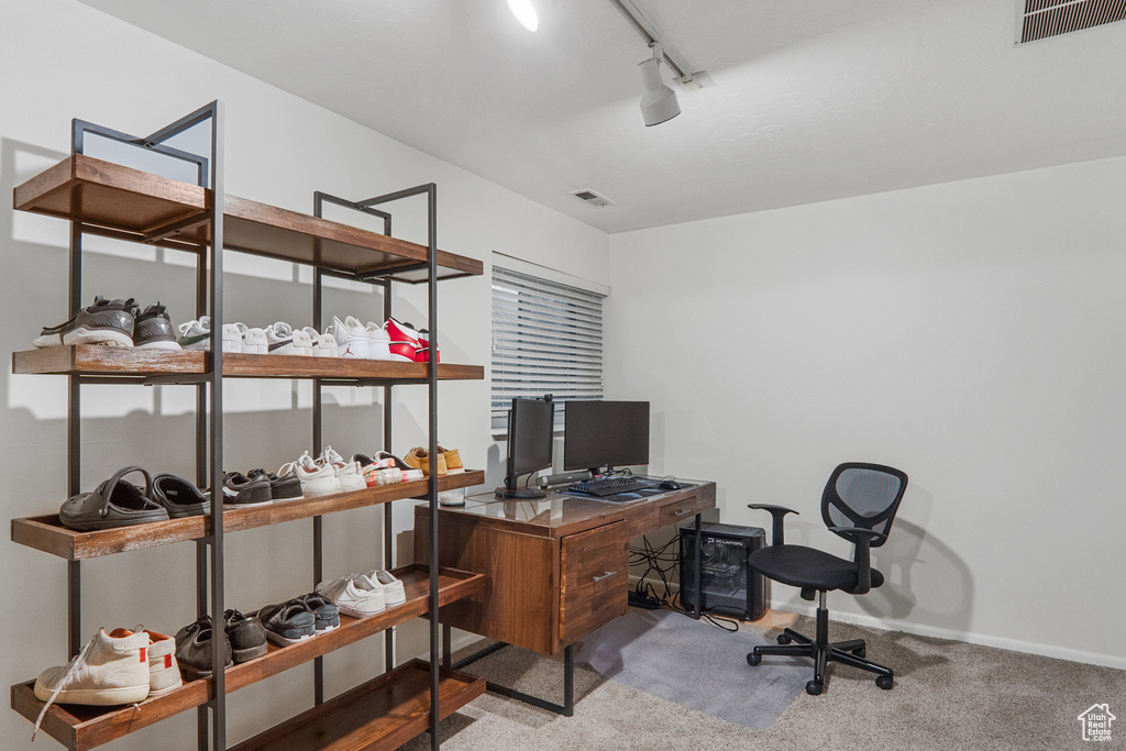 Office featuring carpet floors, baseboards, rail lighting, and visible vents