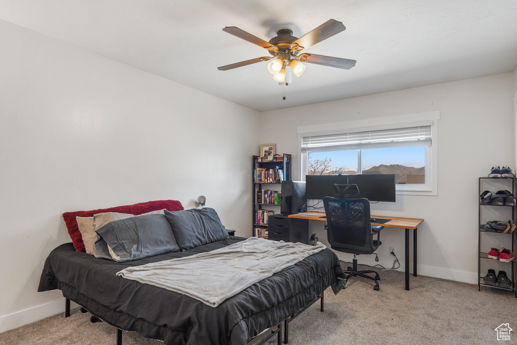 Carpeted bedroom with baseboards and ceiling fan