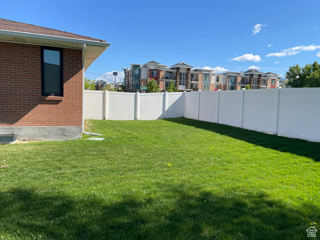 View of yard with a fenced backyard and a residential view