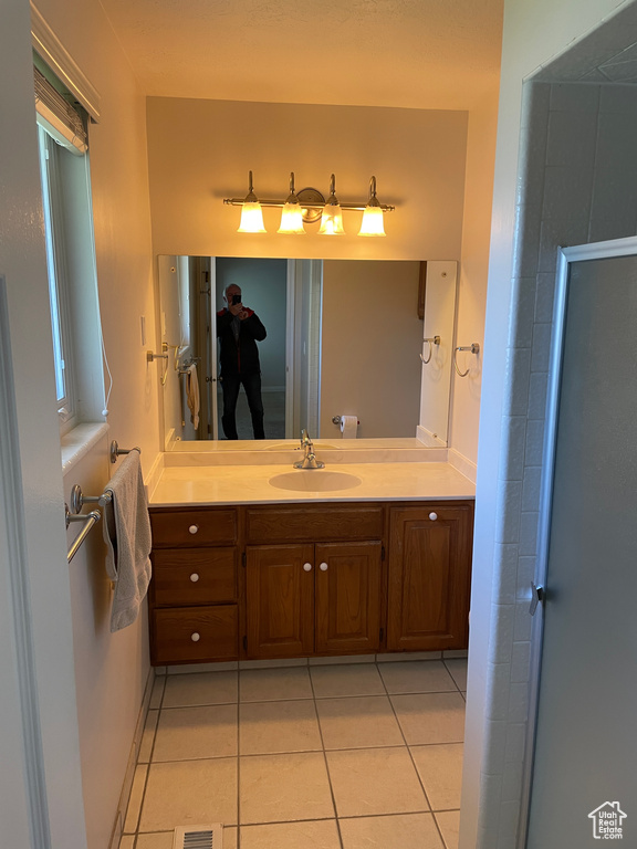 Bathroom featuring tile patterned floors and vanity