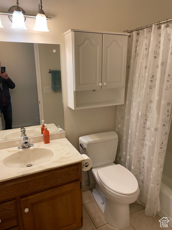 Full bathroom featuring tile patterned flooring, shower / bath combo, toilet, and vanity