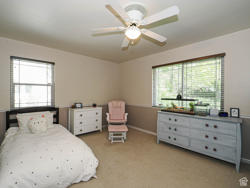 Bedroom with baseboards, ceiling fan, and carpet flooring