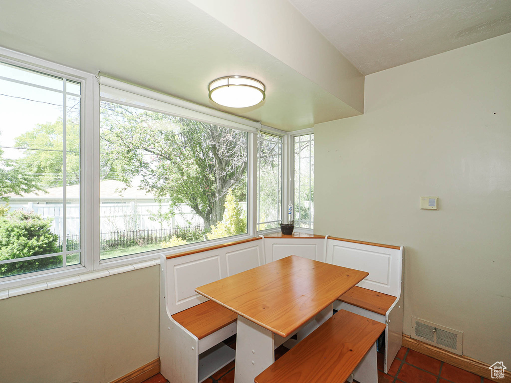 Unfurnished dining area with visible vents and baseboards