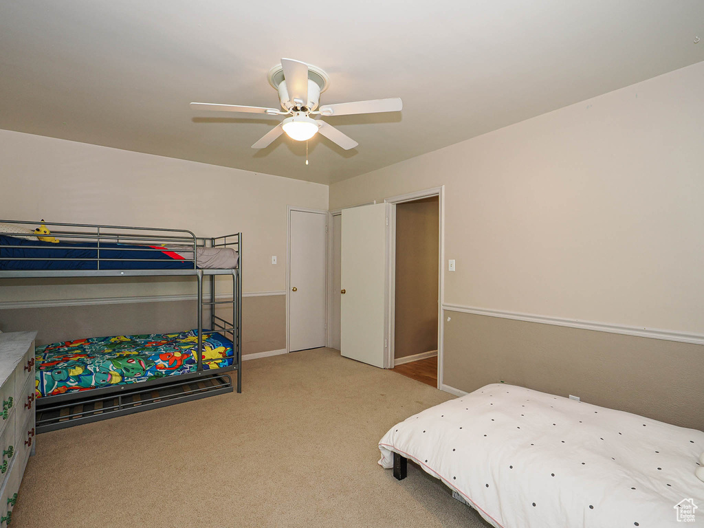 Bedroom featuring carpet floors, ceiling fan, and baseboards