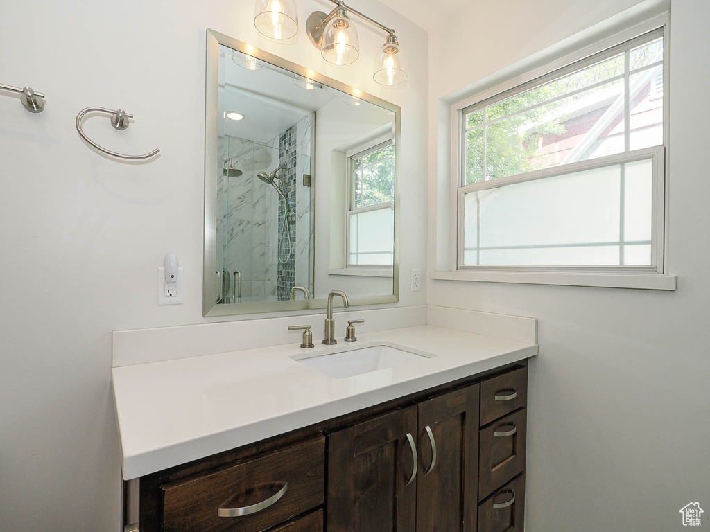 Bathroom with a marble finish shower and vanity