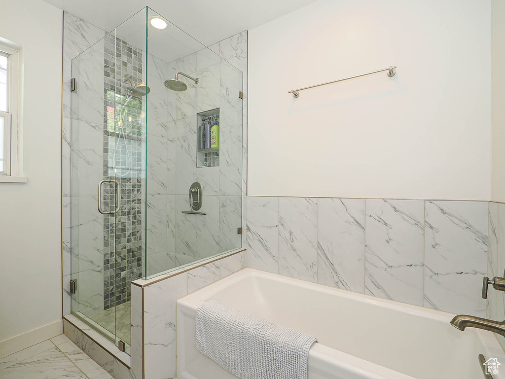 Bathroom with marble finish floor, recessed lighting, baseboards, a shower stall, and a bath